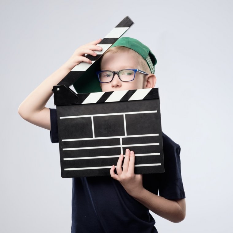 Young boy with clapper board