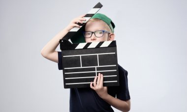 Young boy with clapper board